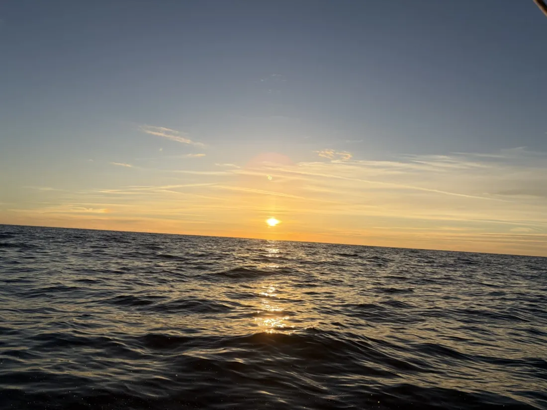 The sun low over the Adriatic, casting a bright reflection across the water
