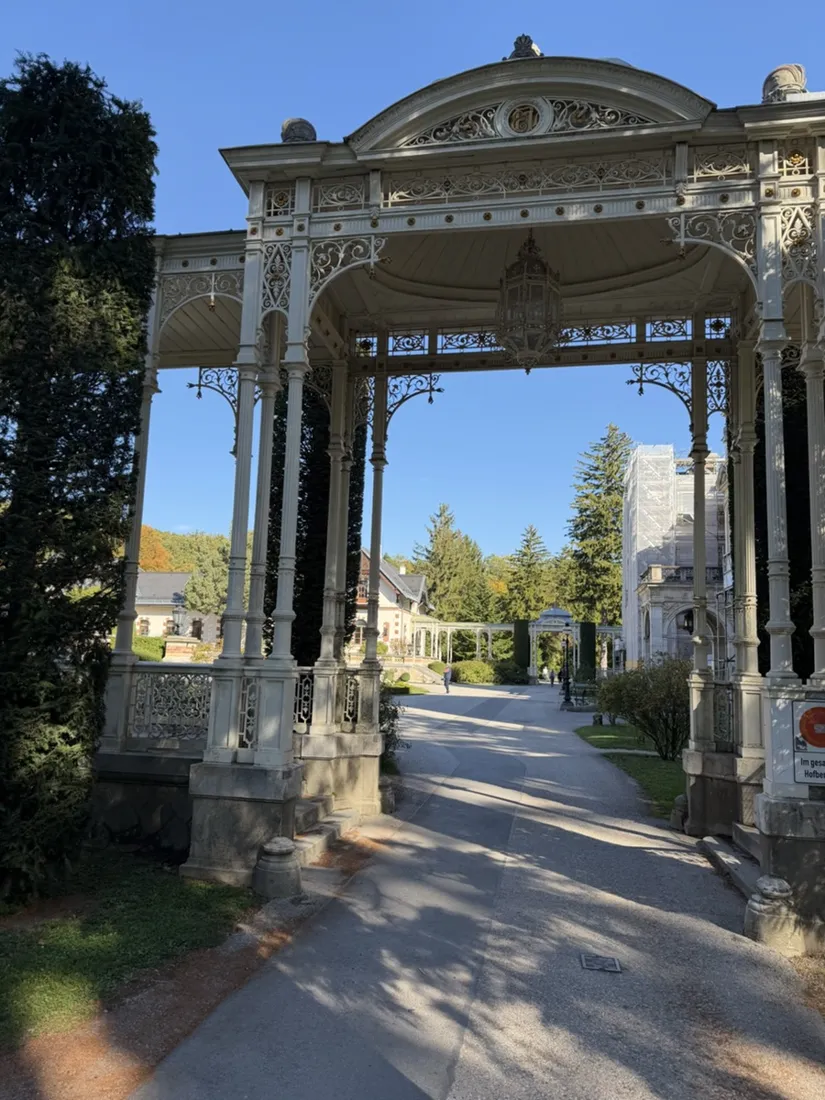 Ornamental ironwork at the entrance to the Hermesvilla grounds, with scaffolding visible beyond