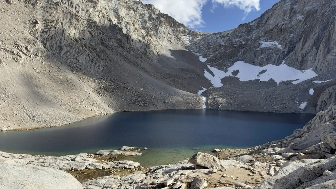 Deep blue tarn and snow patches high on the Mount Whitney Trail