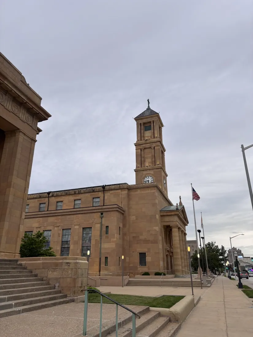 The Cathedral of the Immaculate Conception, a golden Greek-revival church with a clock tower in downtown Springfield